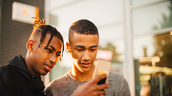 Two males looking at mobile phone