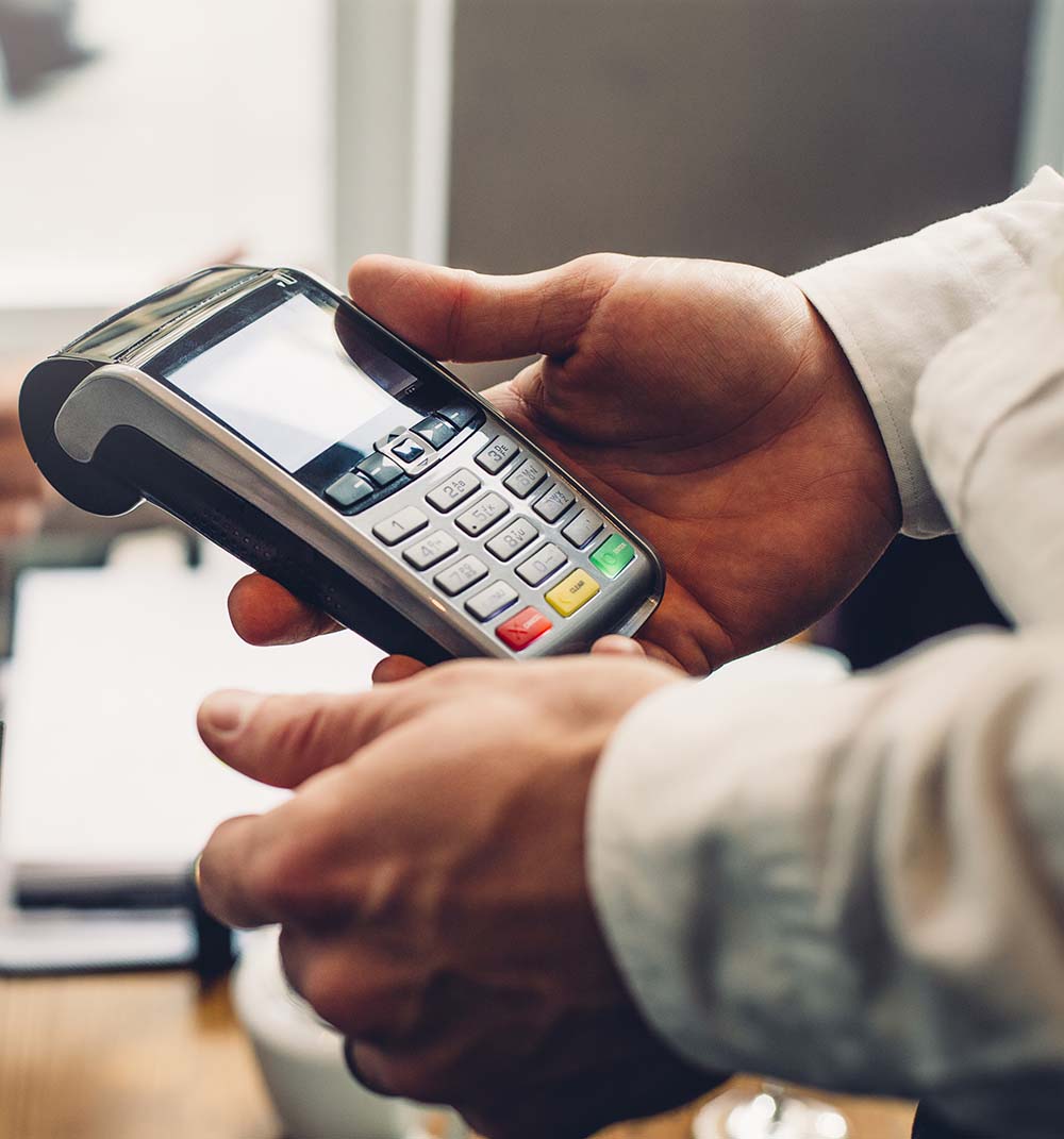 Card machine being held in hands