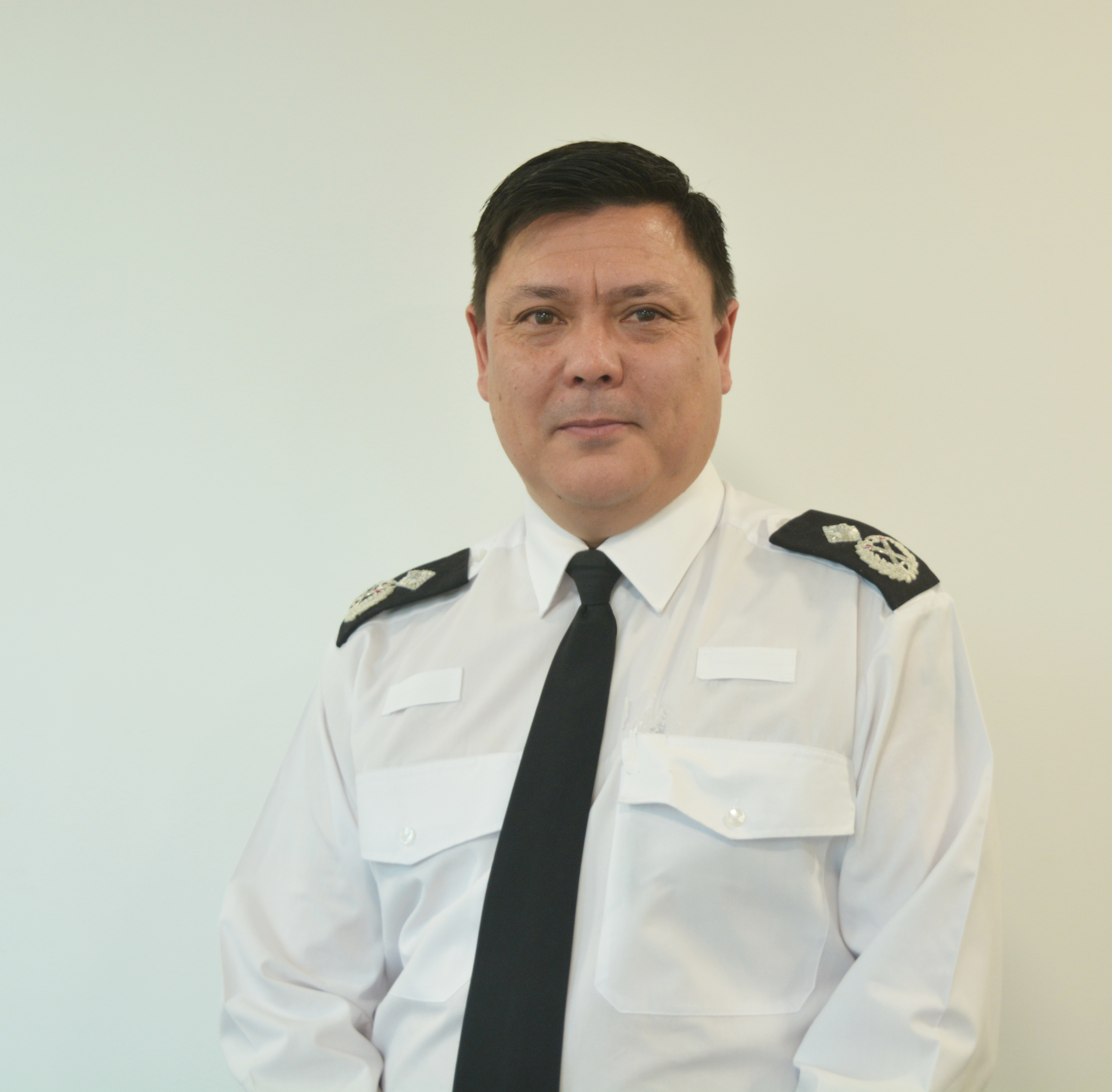 Deputy Chief Constable Phil Cain wearing white shirt black tie and epaulettes 