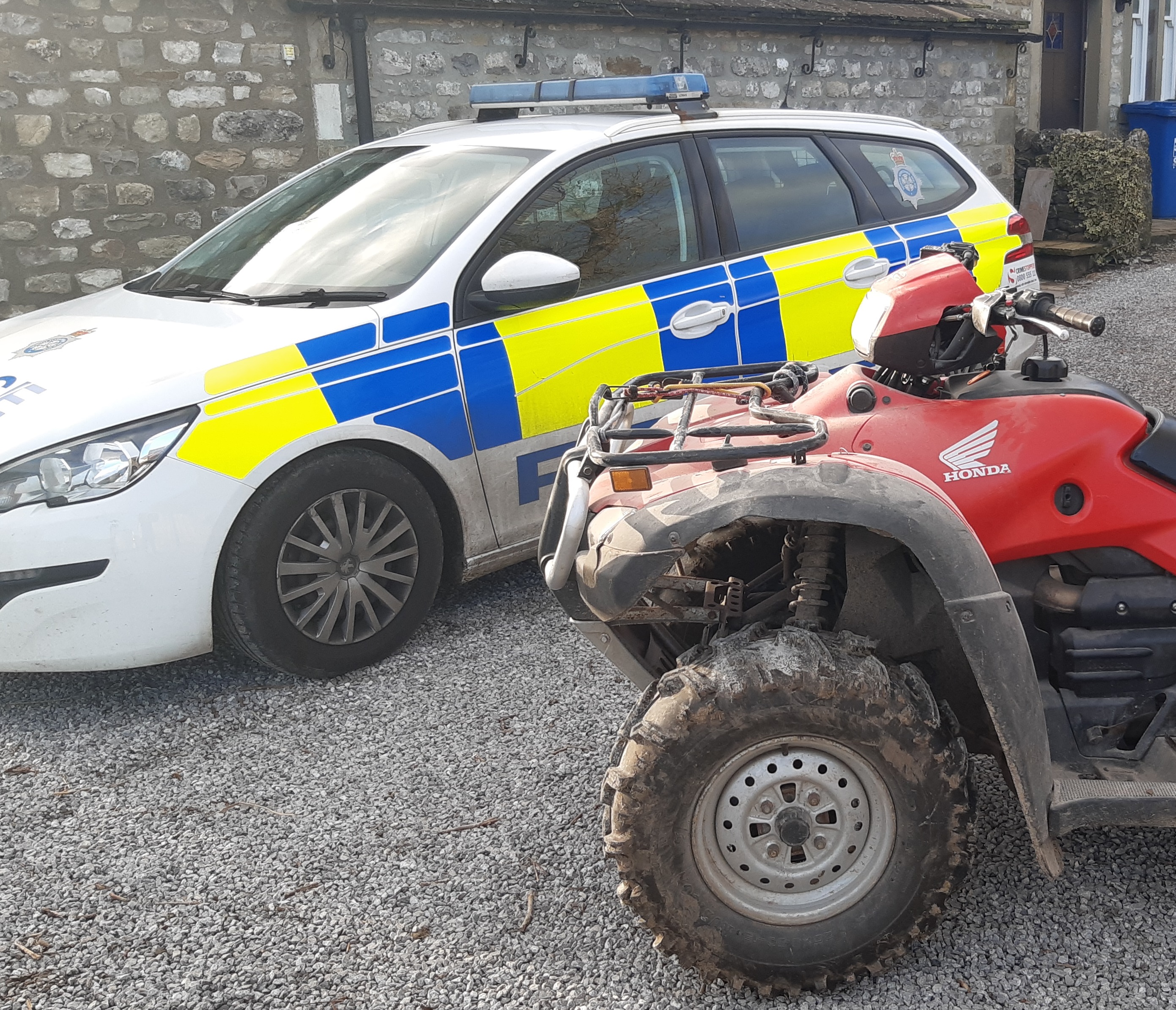 A quad bike and police car