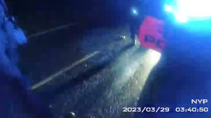 police car on blue lights on road 