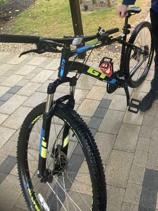 black pedal cycle with blue and neon green trim