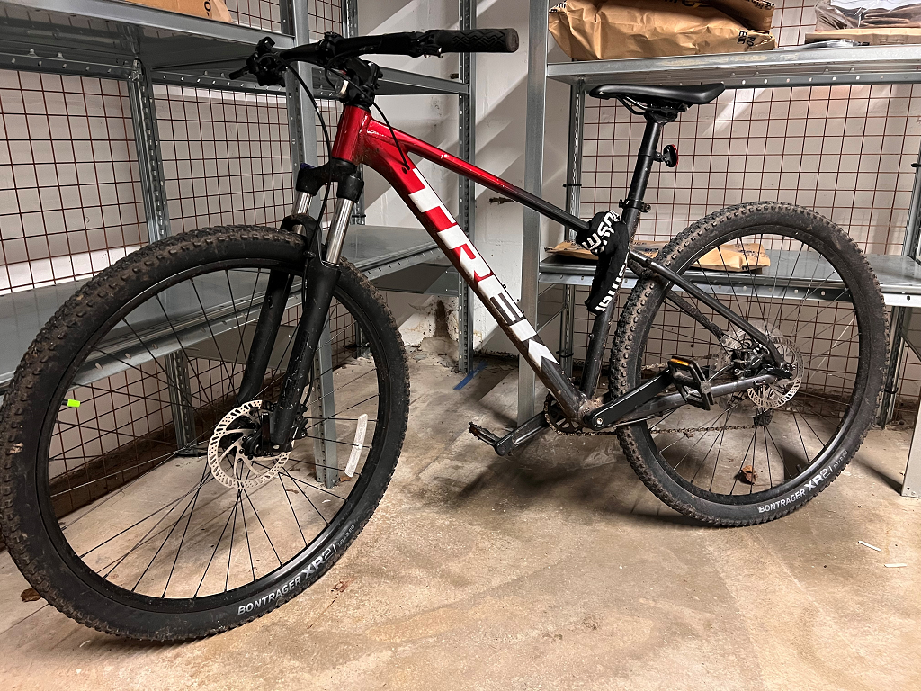 red and black Trek pedal cycle with white writing 