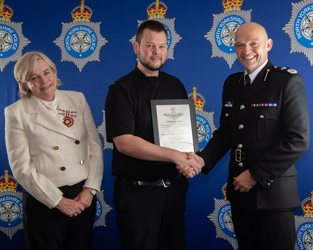 PC McVay's award was presented to him by Countess Charlotte Peel, the Deputy Lieutenant to North Yorkshire (left), and Deputy Chief Constable Scott Bisset (right).