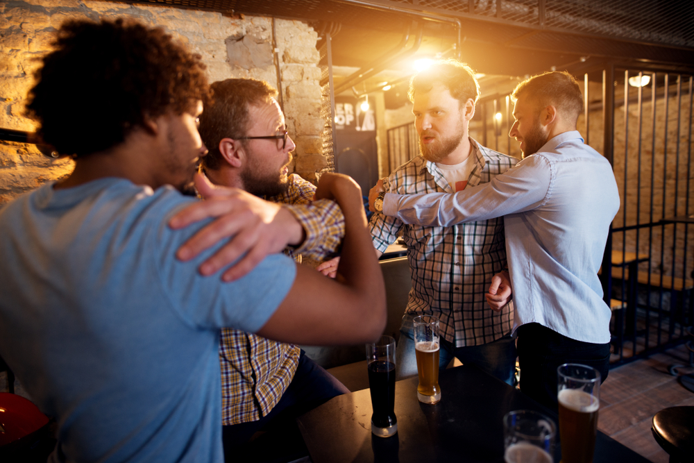 helping friends to walk away from a heated confrontation in bars 