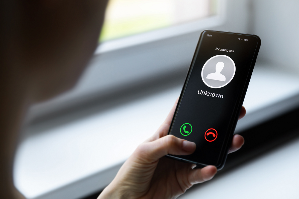 mobile phone showing call from unknown number 