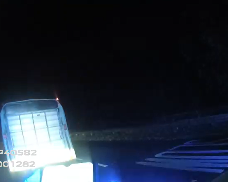back of trailer and blue lights on road 