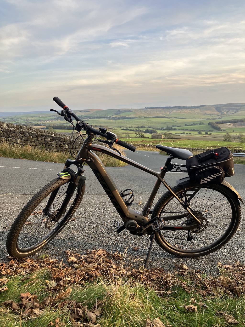 black e-bike with countryside behind it
