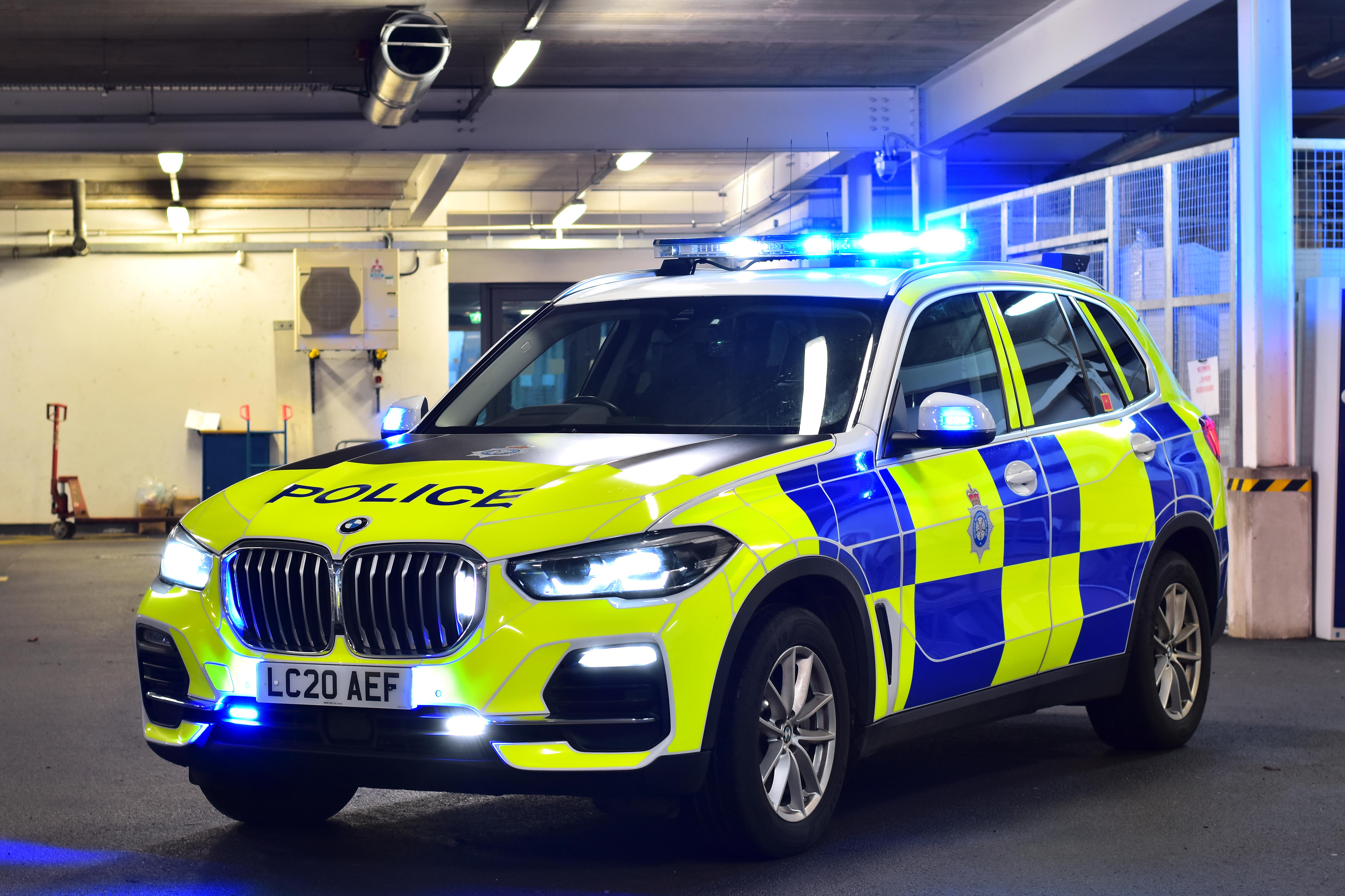Police car in police station with blue lights illuminated