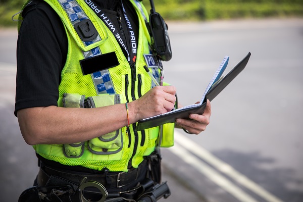 Officer writing in pocket notebook