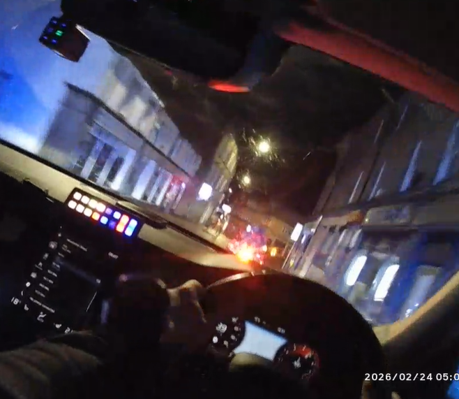 ashboard and view through windscreen of a police car during a pursuit 